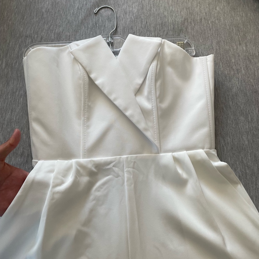 White strapless jumpsuit with pockets and asymmetrical neckline